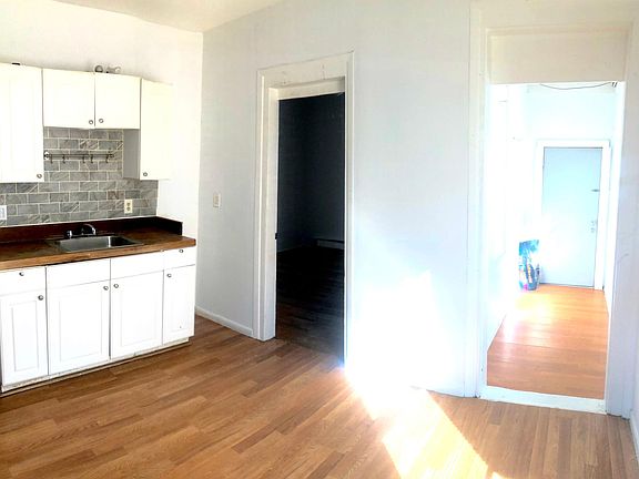 Kitchen, door to room, and rear exit