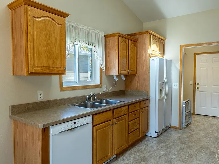 Kitchen with matching appliances, dishwasher, abundant storage