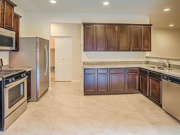Open kitchen includes new energy-efficient appliances and granite counters
