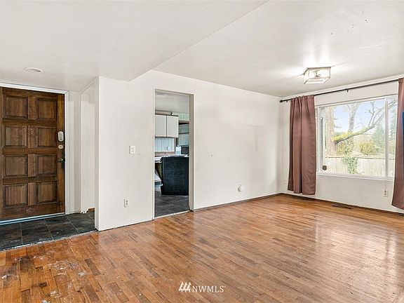 Interior of Front Door Entry, Doorway to Kitchen with Eating Space and Formal Dining/Great Rooms with Oak Hardwood Floors