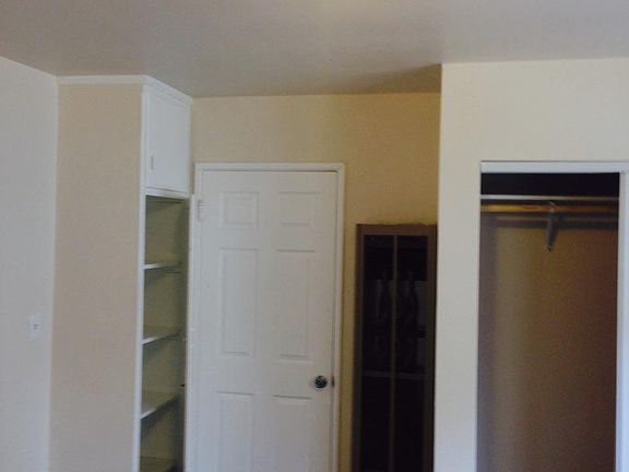 Bedroom with full closet and linen closet; door to living room