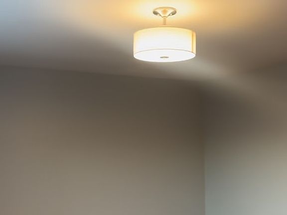 Spacious bedroom with new light fixture