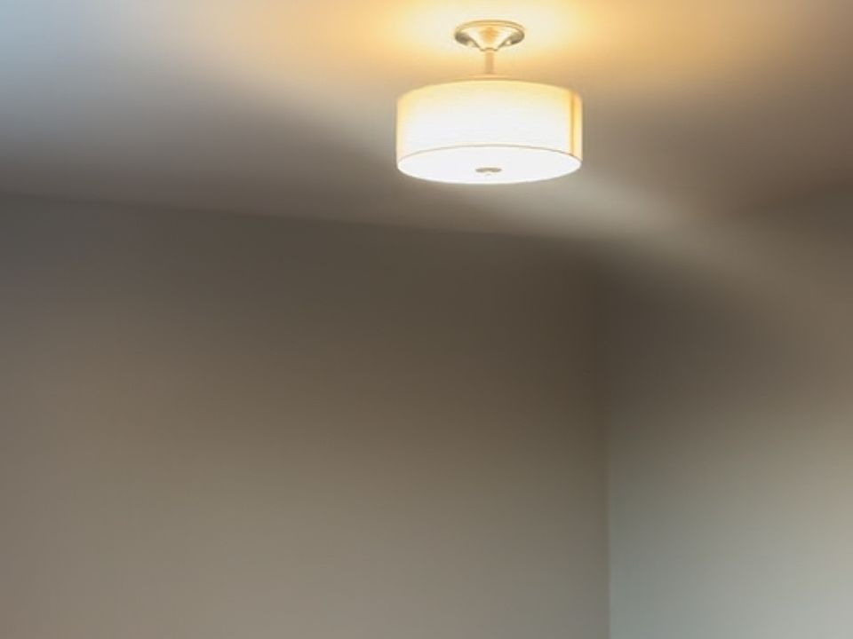 Spacious bedroom with new light fixture