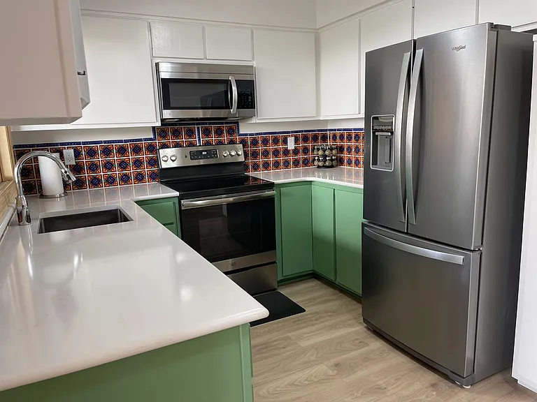 Kitchen with beautiful hand-painted Mexican tile, large sink, and updated appliances.