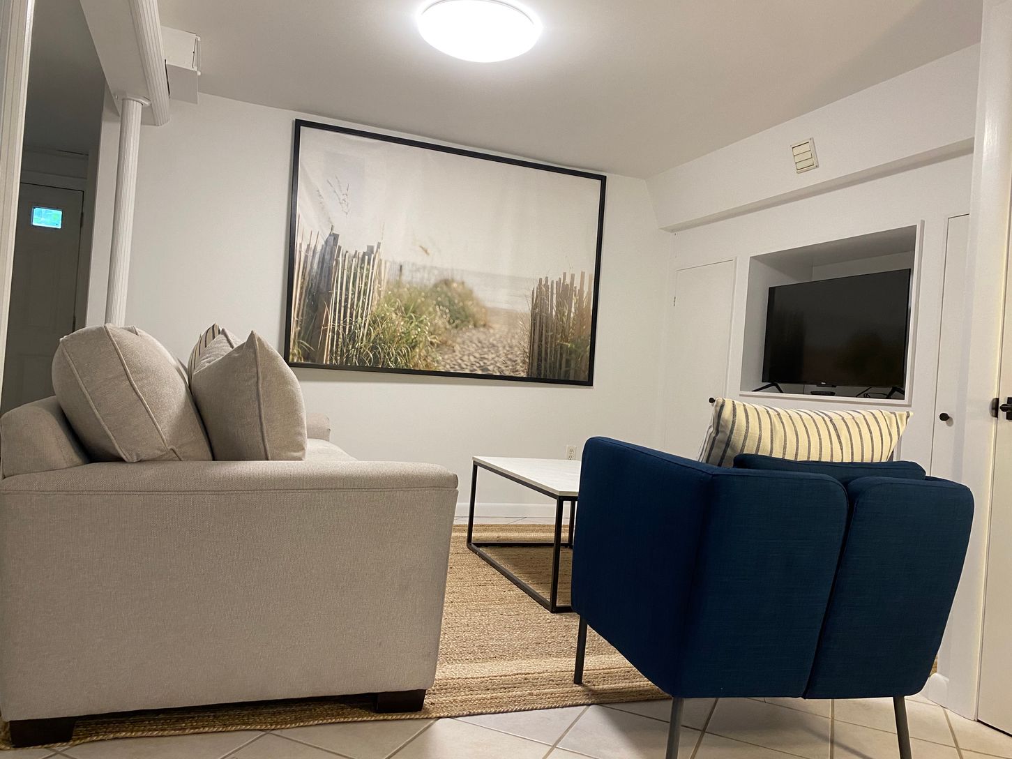  Located on the lower level and adjacent to bedroom 4 is another den with a flat screen tv. 