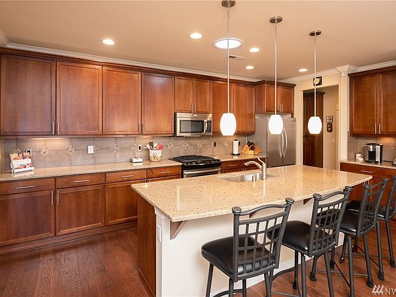 Ample counter space, upgraded tile backsplash, gas cooktop.