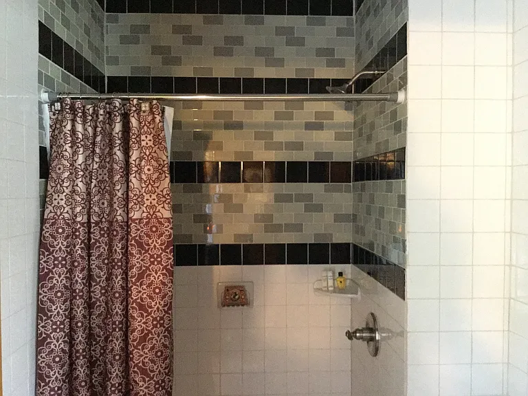 The guest suite features a fully tiled walk-in shower and private ensuite bath.