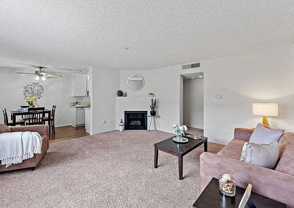 Beautifully staged and upgraded living room with a cozy fireplace at the Ridgeview Apartment in Northridge