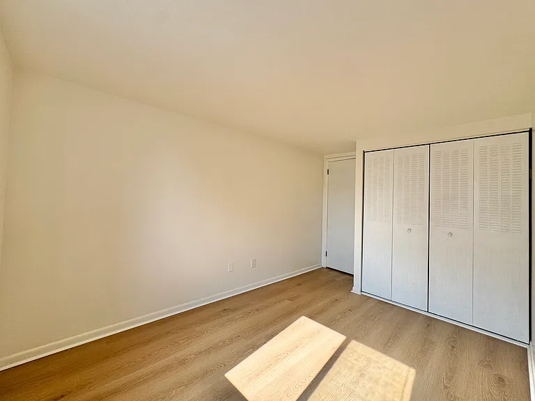 Secondary bedroom with a double-door closet