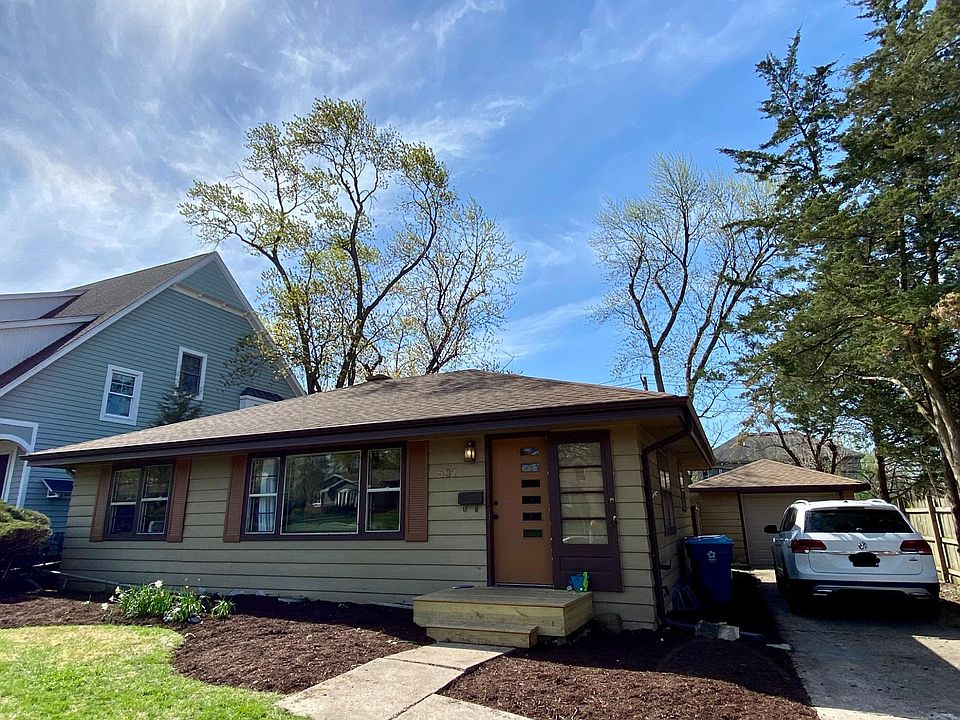 Front, driveway, detached garage.