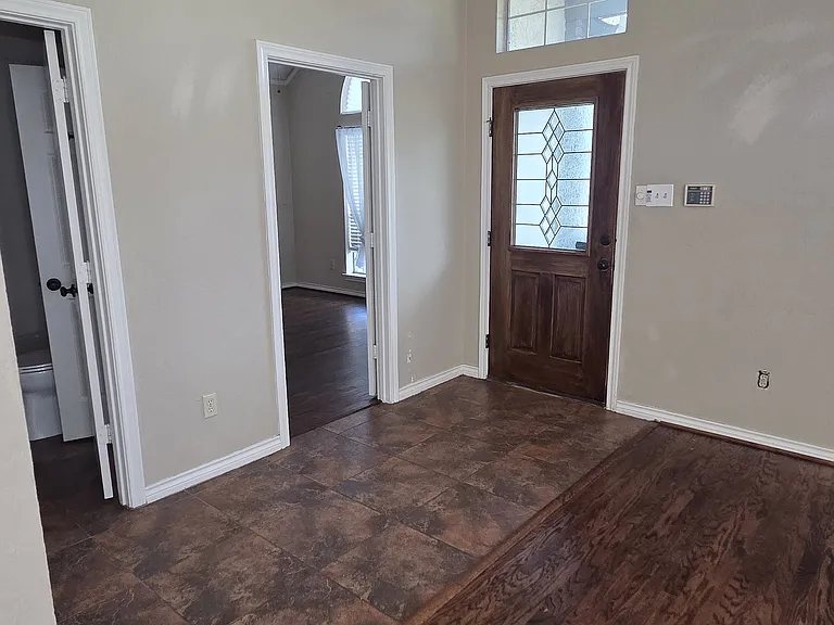 Beautiful tiled entry and foyer with inviting light fixture.
