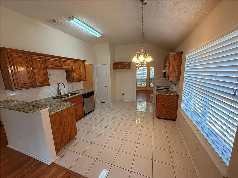 UPDATED KITCHEN WITH GRANITE COUNTERS, NEWER FAUCET, APPLS NEWER, CUSTOM CABINETS. OPEN TO THE DEN WITH BREAKFAST BAR.