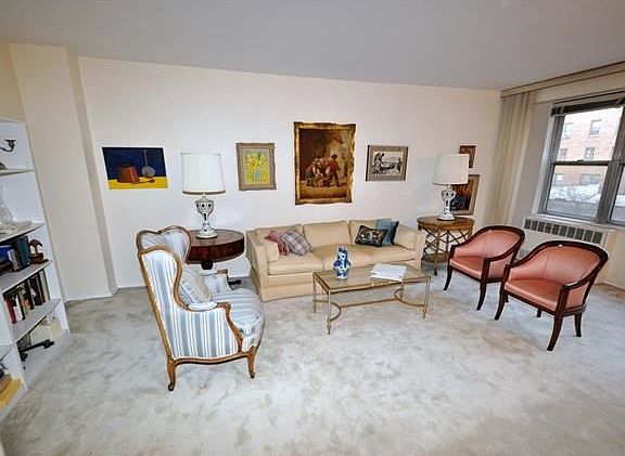 The large living room and "L" shaped dining room has covered parquet floors, wall of windows and overlooks the back courtyard.  The living room is 21'-0" x 12'-3" and the dining area is 10'-0" x 8'-3".