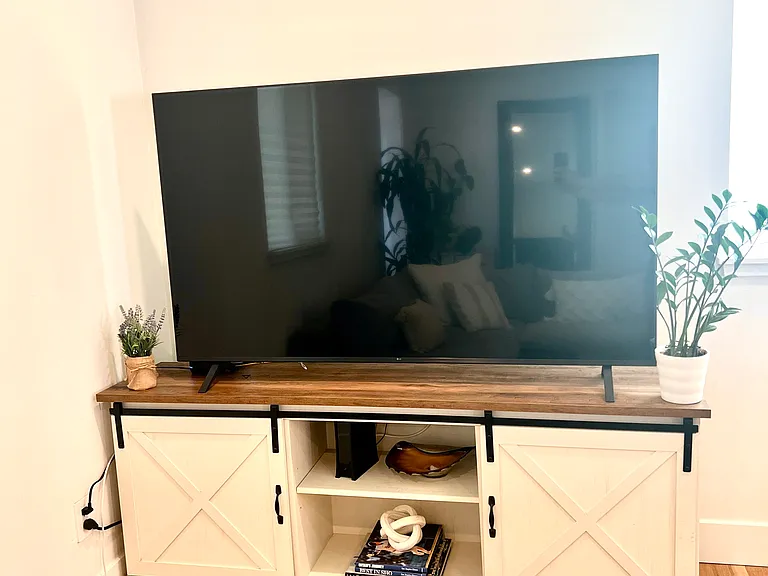 Living Room: Bright, inviting living room with new LG 65" Smart TV