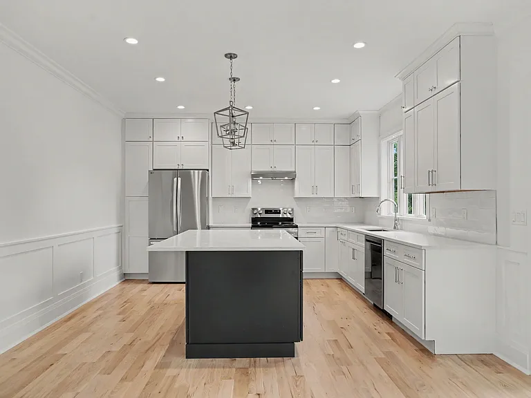 A Sunlit Coastal_Modern Kitchen Featuring White Cabinetry, Sleek Lines, and Premium Designer Finishes.