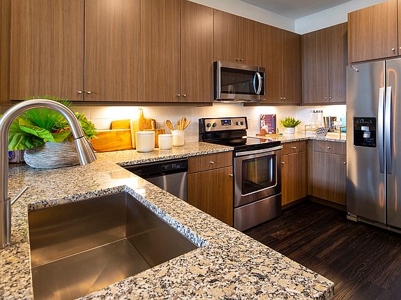 The gourmet kitchens feature stainless steel appliances and granite countertops