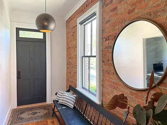 Looking toward the front door + entry hall, from living room area