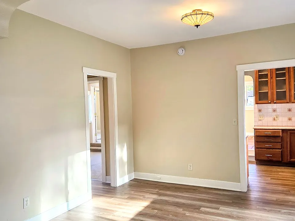 Main room. Kitchen door on right. Left door is hallway between bath and 3rd bedroom.
