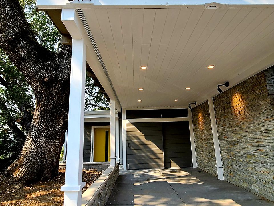 Tenant parking with view of lockable carport storage units and front door
