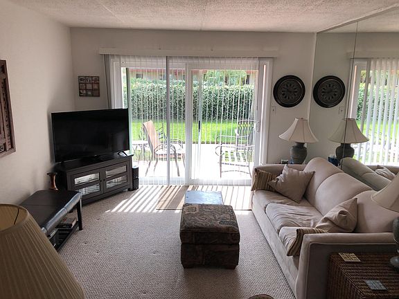 Spacious entertainers living room with Wifi, 50" HD television, and view of the pool.