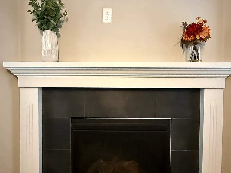 Outlet above for easy TV mounting above gas fireplace.