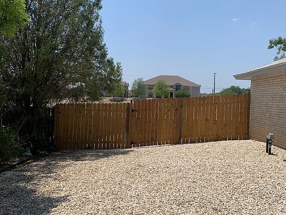 Left side of house (gate access)