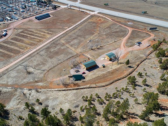 An aerial overview of the property, which shows the cabin, the converted barn, and the remaining barn.