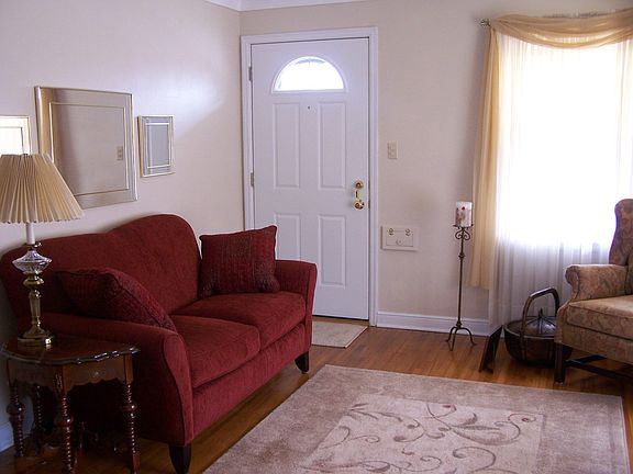 Living rm featuring gleaming hardwood floors and neutral calming colors.