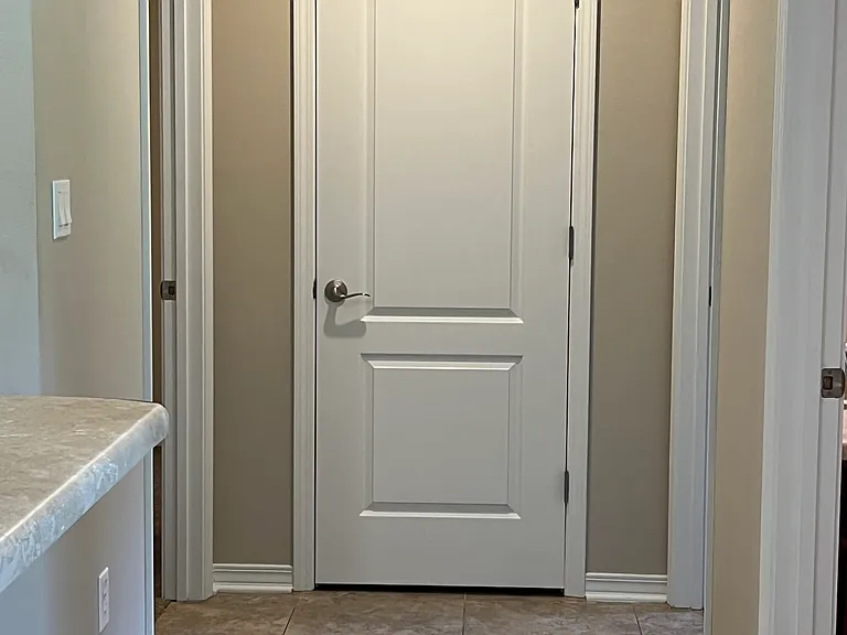 Hallway in between 2 bedrooms on the kitchen side