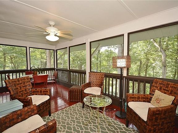 Fantastic screened-in porch adjacent to the living/dining area with ceiling fan, outside door to deck and panoramic, private,ser