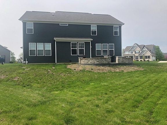 Attractive exterior of home has brick and Hardiplank cement board.