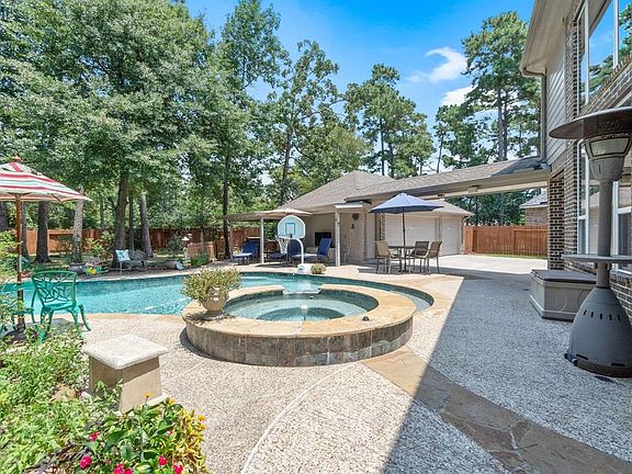 Wooded backyard with sparkling pool and spa