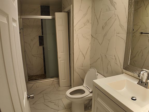 tile bathroom with walk-in shower