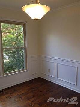 Formal dining room with chair rail, crown molding and new paint and flooring