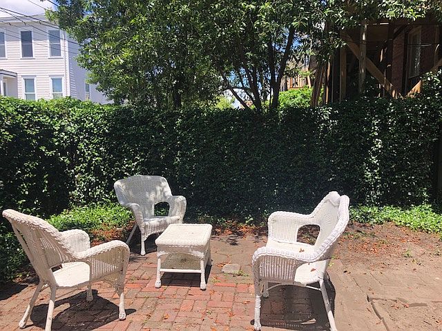 Private, spacious courtyard with outdoor furniture.
