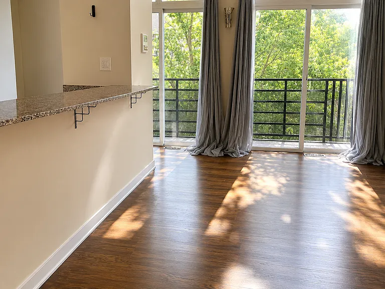 Expansive west-facing balcony with three sliding glass doors