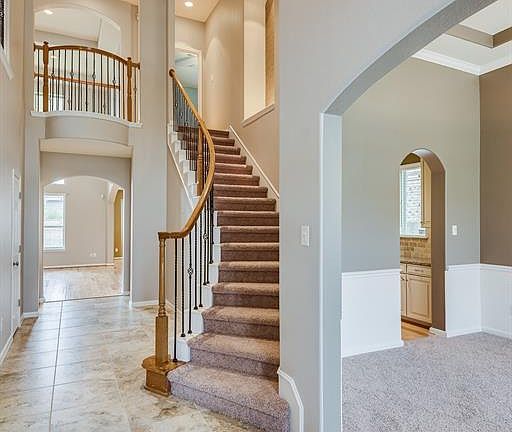 INSIDE, YOU'LL FIND A GRAND FOYER WITH COFFERED CEILING.
