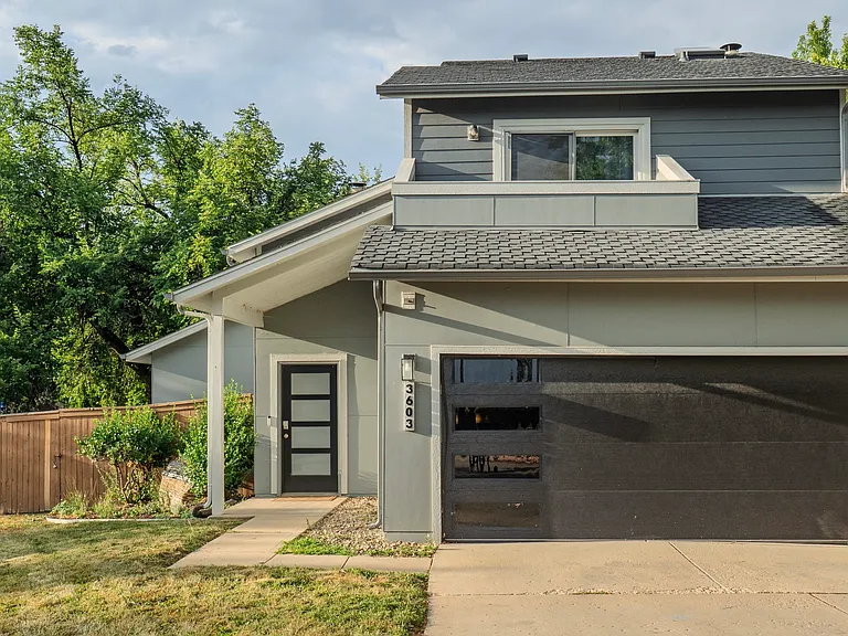 Large two car garage with lots of shelving and cabinets for storage