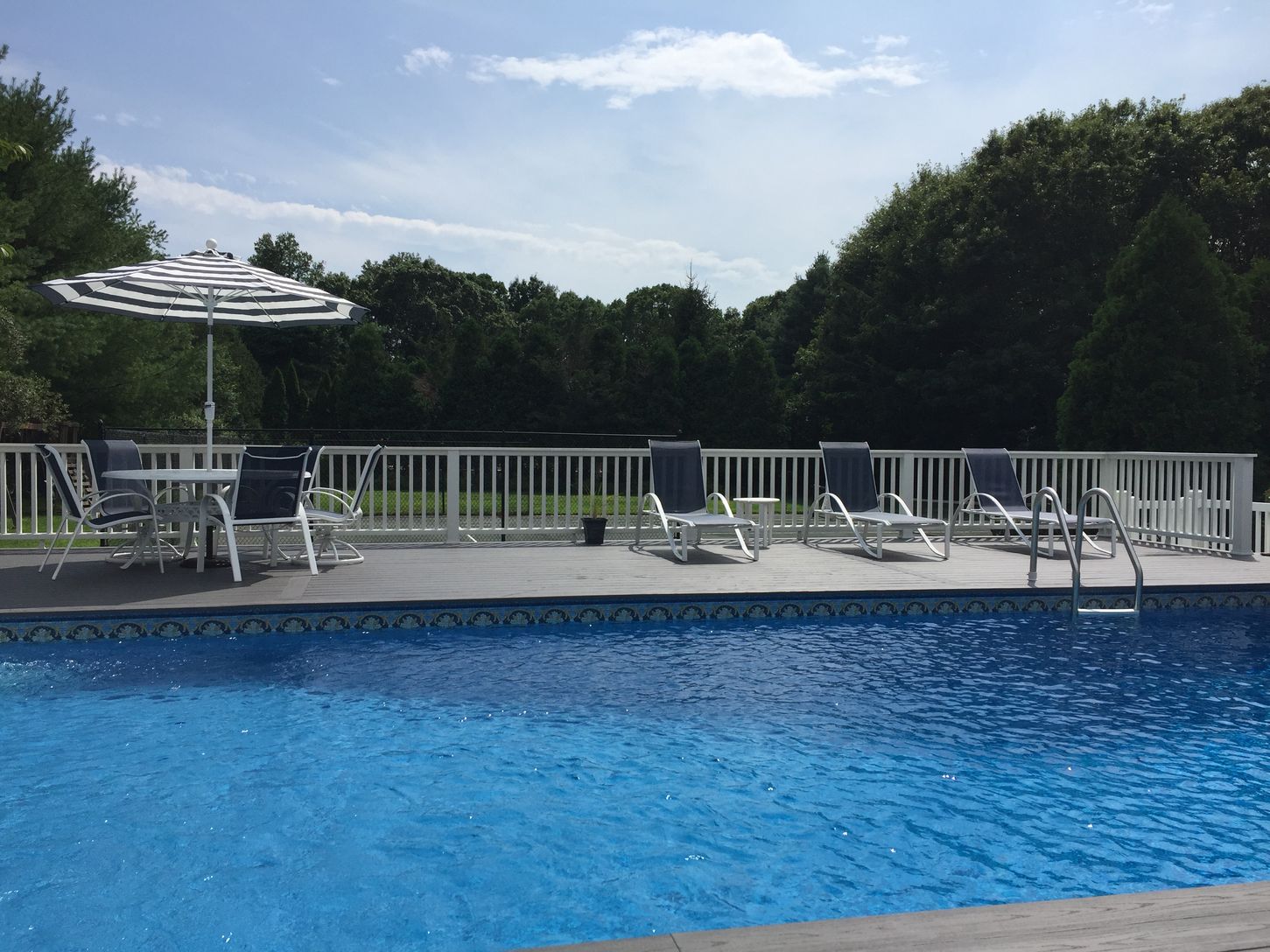  Heated Swimming Pool with updated deck furniture to relax on.