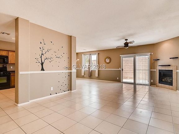 Family Room Area Showing Fireplace and Sliding Door Leading to Backyard
