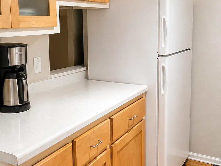Kitchen with full size refrigerator, microwave, and cabinet space.