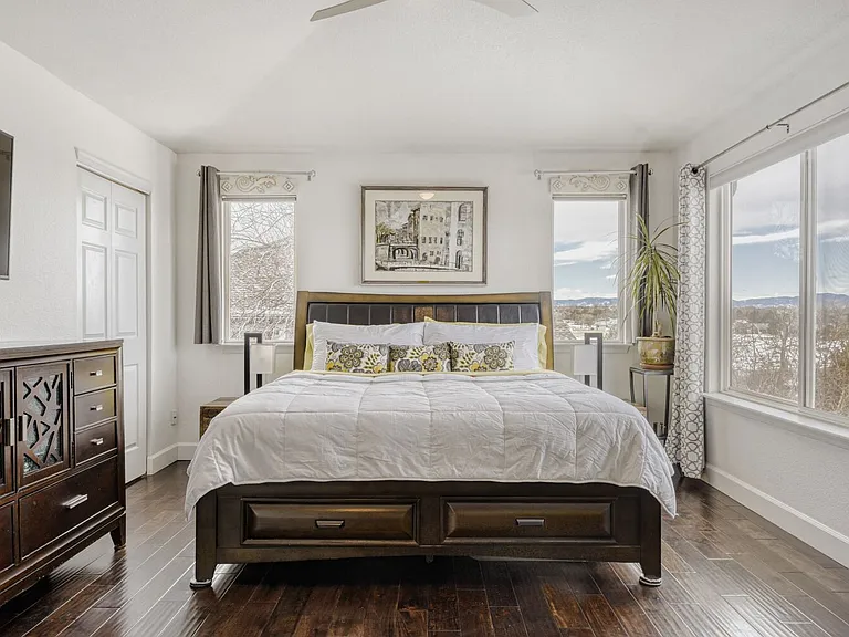 Large Primary bedroom has gorgeous views of Rockies and Golf Course