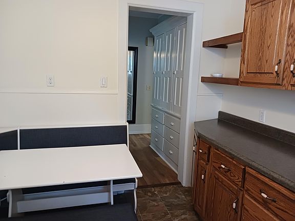 Large hall pantry that enters a kitchen with a small seating if you desire to use.