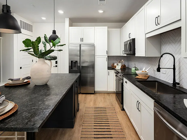 Contemporary Kitchen with Dark Countertops, White Cabinets & Undermount Sink