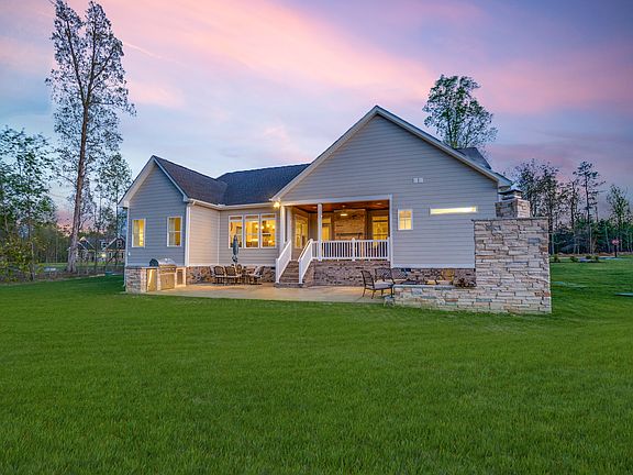The Lynn with stamped concrete patio and outdoor kitchen