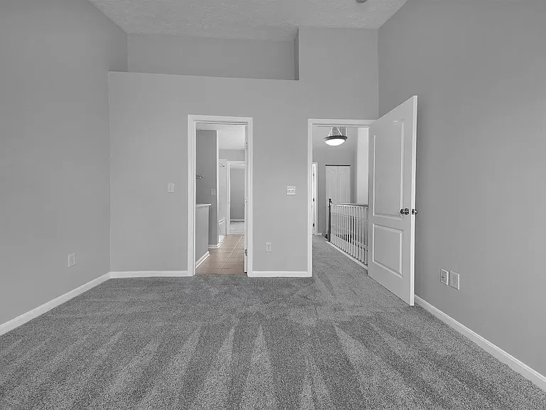 Back bedroom with vaulted ceiling - hallway view