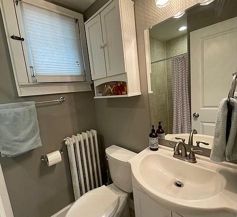 Bathroom (lighted shower reflected in mirror)