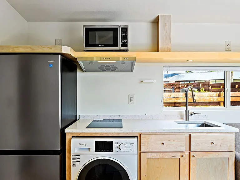 Kitchen with Stone Top, Induction Cooktop, Microwave & Fridge/Freezer, plus Washer/Dryer Combo