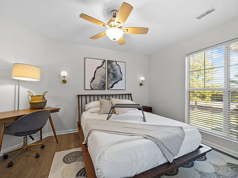 2nd bedroom with desk and queen bed.