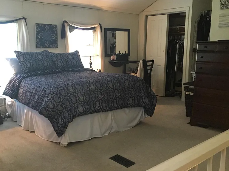 bedroom shown with previous tenants furniture